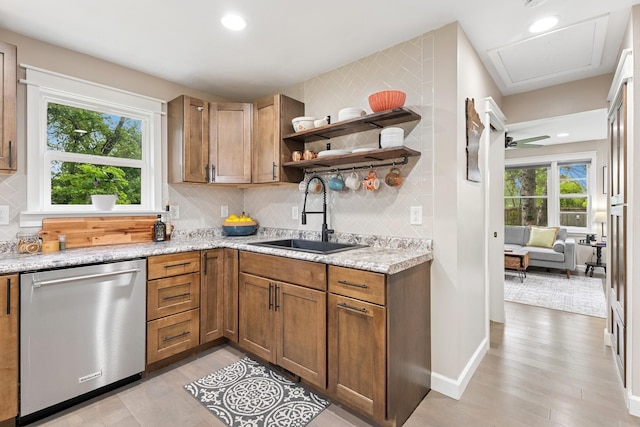 3178 253rd Ave NW, Isanti, MN 55040 - kitchen with stainless steel dishwasher, light wood finished floors, backsplash, light stone counters, and recessed lighting
