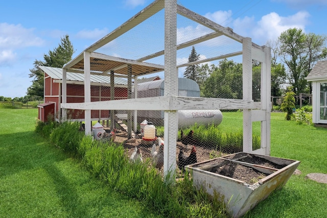 3178 253rd Ave NW, Isanti, MN 55040 - view of grassy yard with exterior structure, an outbuilding, and a garden