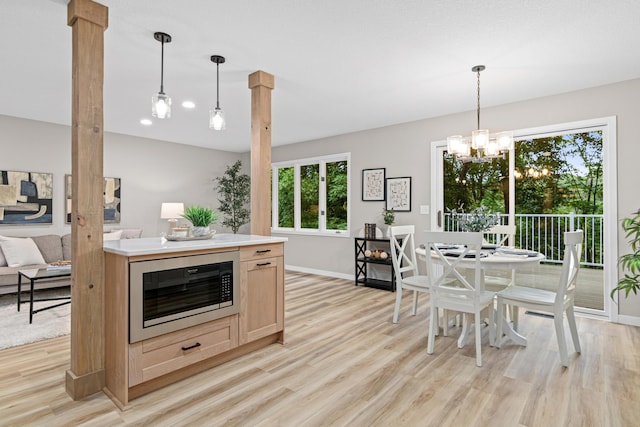 6980 Crest Dr, Maple Grove, MN 55311 - kitchen with built in microwave, light brown cabinets, light wood finished floors, and a chandelier