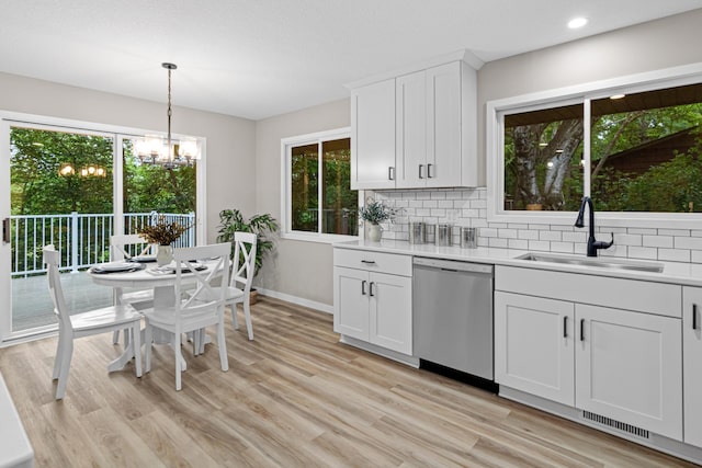 6980 Crest Dr, Maple Grove, MN 55311 - kitchen featuring stainless steel dishwasher, healthy amount of natural light, light countertops, backsplash, and recessed lighting