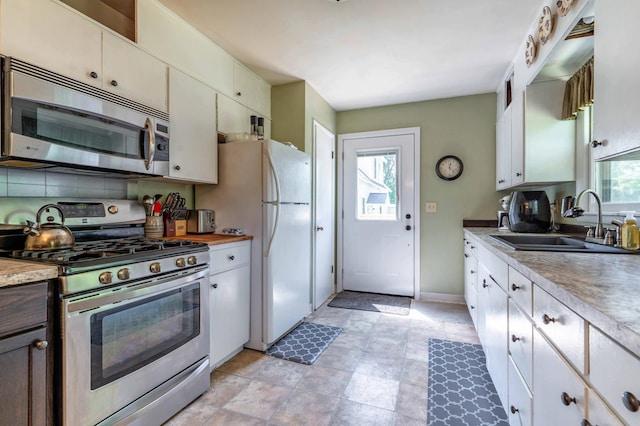 707 Marshall Ave, Henning, MN 56551 - kitchen with stainless steel appliances, light countertops, and decorative backsplash