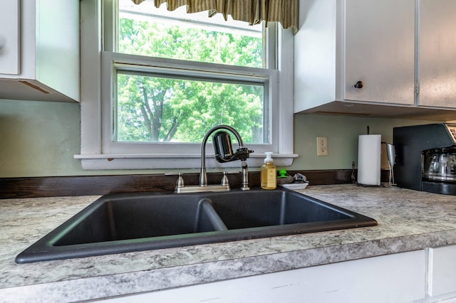 707 Marshall Ave, Henning, MN 56551 - kitchen featuring white cabinets and light countertops