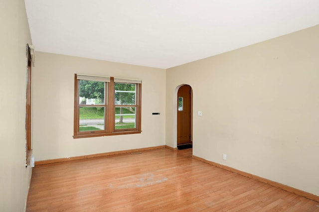 5709 26th Ave S, Minneapolis, MN 55417 - empty room featuring arched walkways and light wood-type flooring