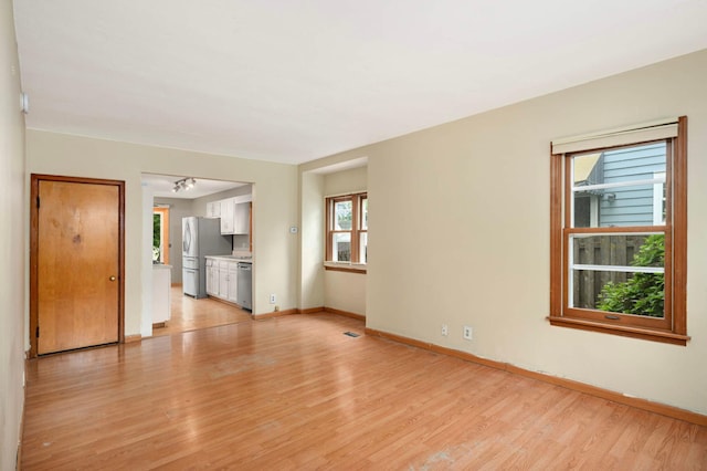 5709 26th Ave S, Minneapolis, MN 55417 - unfurnished living room featuring light wood-type flooring and baseboards