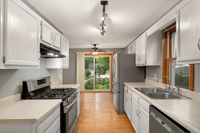5709 26th Ave S, Minneapolis, MN 55417 - kitchen featuring appliances with stainless steel finishes, under cabinet range hood, ceiling fan, light countertops, and white cabinetry