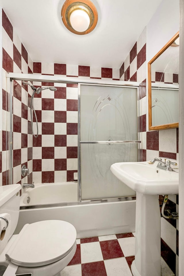 5709 26th Ave S, Minneapolis, MN 55417 - bathroom with combined bath / shower with glass door, tile patterned floors, and tile walls
