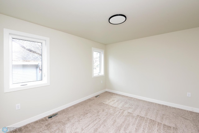 1109 University Dr S, Fargo, ND 58103 - unfurnished room featuring light carpet and baseboards