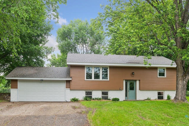 711 9th St NW, Buffalo, MN 55313 - split foyer home featuring a front yard, driveway, a garage, and a shingled roof