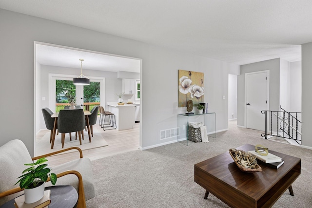 711 9th St NW, Buffalo, MN 55313 - living room with light carpet and baseboards