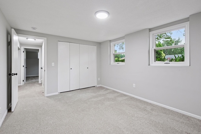 711 9th St NW, Buffalo, MN 55313 - unfurnished bedroom featuring light carpet and a closet