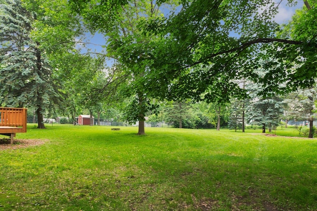 711 9th St NW, Buffalo, MN 55313 - view of yard with a deck and a shed