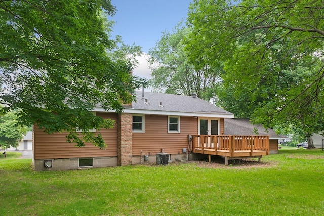 711 9th St NW, Buffalo, MN 55313 - back of house with a wooden deck, a lawn, french doors, and roof with shingles