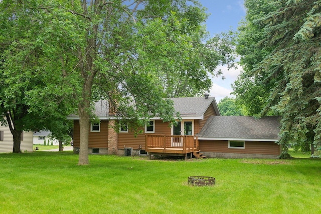 711 9th St NW, Buffalo, MN 55313 - back of house with a lawn, a deck, and a shingled roof