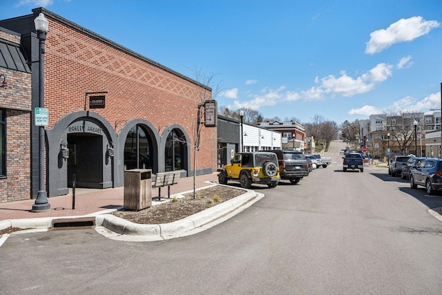 711 9th St NW, Buffalo, MN 55313 - view of asphalt street featuring street lights, curbs, sidewalks, and traffic signs