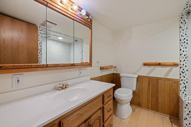 2236 Birch Point Rd Unit A, Tower, MN 55790 - full bathroom with a wainscoted wall, vanity, tiled shower, wood finished floors, and wooden walls