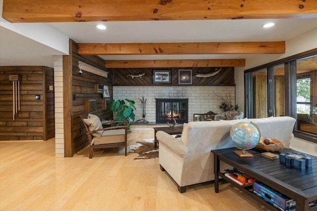 2236 Birch Point Rd Unit A, Tower, MN 55790 - living area featuring light wood-type flooring, a brick fireplace, beamed ceiling, recessed lighting, and brick wall