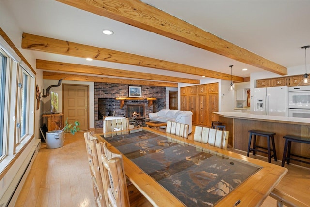 2236 Birch Point Rd Unit A, Tower, MN 55790 - dining room with baseboard heating, light wood-style flooring, recessed lighting, beamed ceiling, and a fireplace