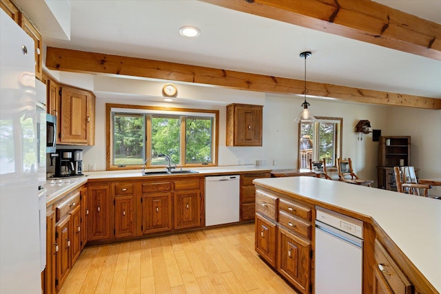 2236 Birch Point Rd Unit A, Tower, MN 55790 - kitchen featuring white appliances, brown cabinets, beam ceiling, light countertops, and plenty of natural light