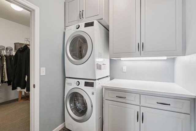 15382 71st St NE, Otsego, MN 55330 - washroom featuring stacked washer and clothes dryer, cabinet space, and carpet