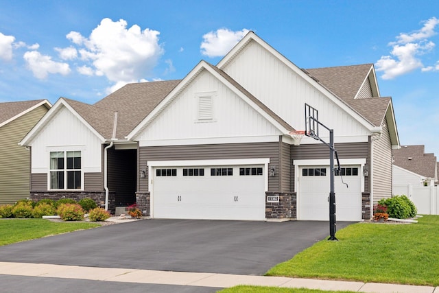 15382 71st St NE, Otsego, MN 55330 - craftsman inspired home featuring stone siding, board and batten siding, roof with shingles, driveway, and an attached garage