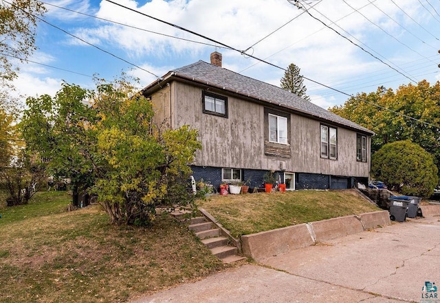 619 18th Ave E, Duluth, MN 55812 - view of side of property featuring a chimney, a lawn, an attached garage, and a shingled roof