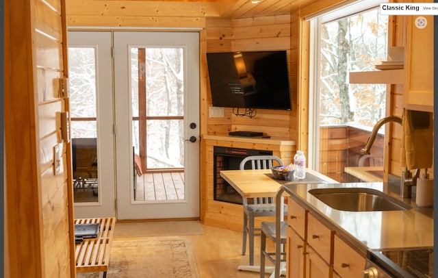 W160655 Hogback Rd Unit 5, Rusk Twp, WI 54728 - kitchen featuring plenty of natural light, wooden walls, light wood-type flooring, and stove