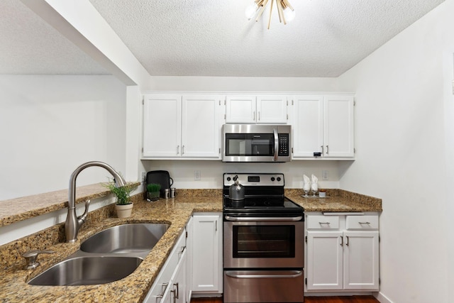 2060 Shenandoah Ct Unit F, Plymouth, MN 55447 - kitchen featuring stainless steel appliances, a textured ceiling, white cabinetry, and light stone counters