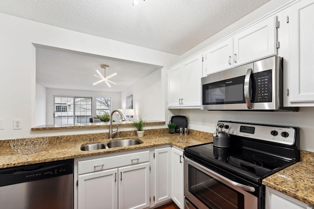 2060 Shenandoah Ct Unit F, Plymouth, MN 55447 - kitchen with appliances with stainless steel finishes, white cabinetry, light stone countertops, and a textured ceiling