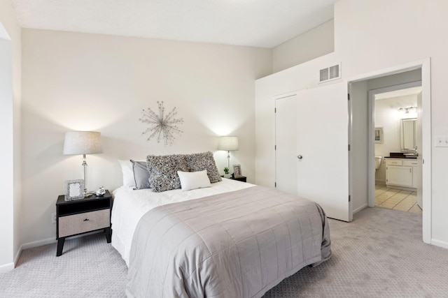 2060 Shenandoah Ct Unit F, Plymouth, MN 55447 - bedroom with light carpet, connected bathroom, and vaulted ceiling