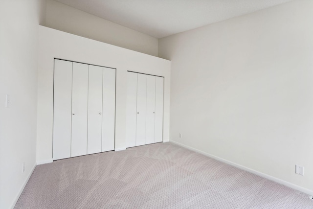 2060 Shenandoah Ct Unit F, Plymouth, MN 55447 - unfurnished bedroom with carpet flooring and two closets
