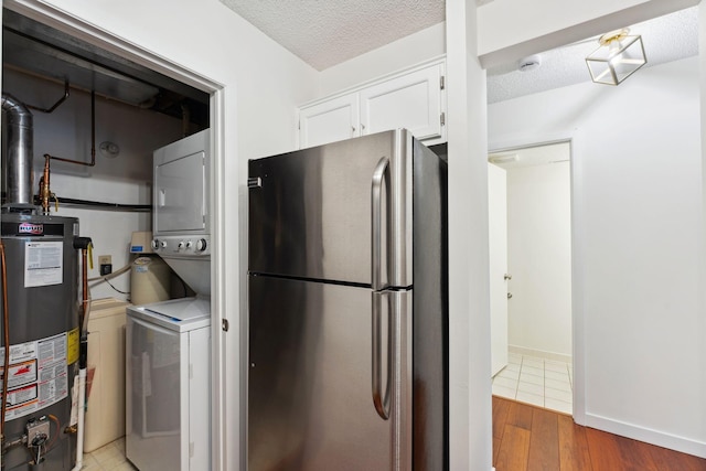 2060 Shenandoah Ct Unit F, Plymouth, MN 55447 - laundry room with stacked washer / dryer, gas water heater, a textured ceiling, and light wood-style flooring