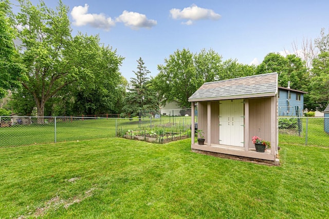 2115 3rd Ave NE, Owatonna, MN 55060 - fenced backyard featuring a vegetable garden and a storage unit