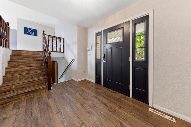 2115 3rd Ave NE, Owatonna, MN 55060 - entrance foyer with dark wood-type flooring, a textured wall, and stairway