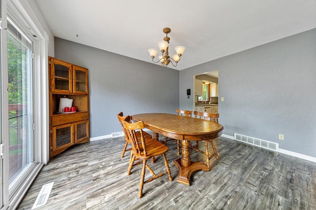 2115 3rd Ave NE, Owatonna, MN 55060 - dining area with a chandelier, wood finished floors, plenty of natural light, and a textured wall
