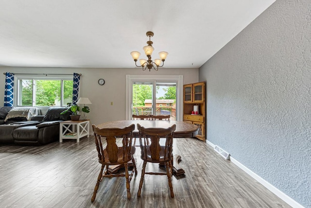 2115 3rd Ave NE, Owatonna, MN 55060 - dining area featuring a textured wall, a chandelier, and wood finished floors