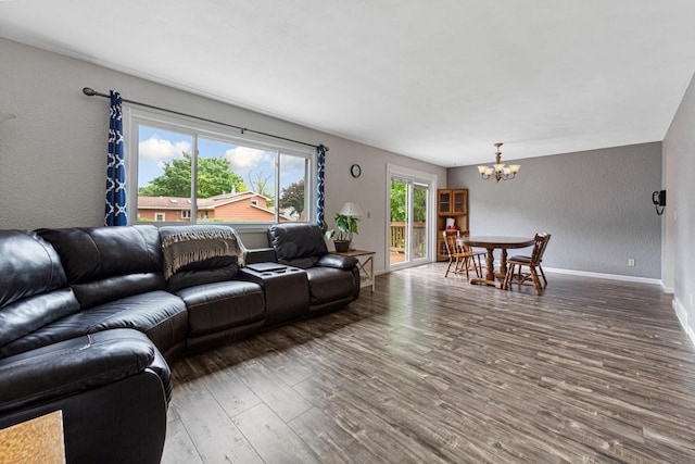 2115 3rd Ave NE, Owatonna, MN 55060 - living room with a chandelier, a textured wall, and wood finished floors