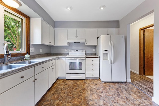 2115 3rd Ave NE, Owatonna, MN 55060 - kitchen with white appliances, under cabinet range hood, white cabinets, and dark stone finish flooring