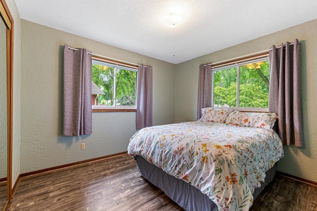 2115 3rd Ave NE, Owatonna, MN 55060 - bedroom with wood finished floors, a textured wall, and a textured ceiling