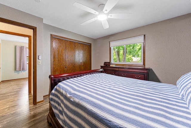 2115 3rd Ave NE, Owatonna, MN 55060 - bedroom featuring wood finished floors, a textured wall, a closet, and ceiling fan