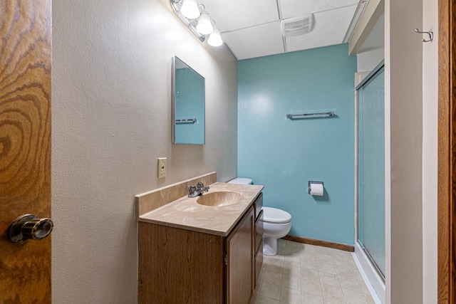 2115 3rd Ave NE, Owatonna, MN 55060 - bathroom with vanity, a paneled ceiling, a shower stall, and tile patterned flooring