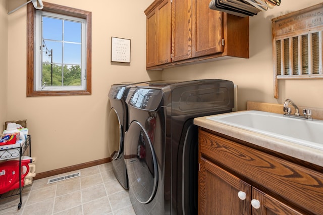 1805 Maple Ln, Saint Cloud, MN 56304 - laundry room featuring cabinet space, washing machine and dryer, and light tile patterned floors