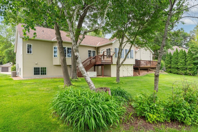 1805 Maple Ln, Saint Cloud, MN 56304 - rear view of property featuring a deck, stairs, a storage unit, a lawn, and roof with shingles