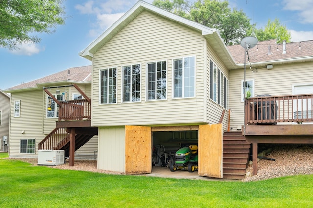 1805 Maple Ln, Saint Cloud, MN 56304 - rear view of house featuring stairs, a deck, a yard, and an attached garage