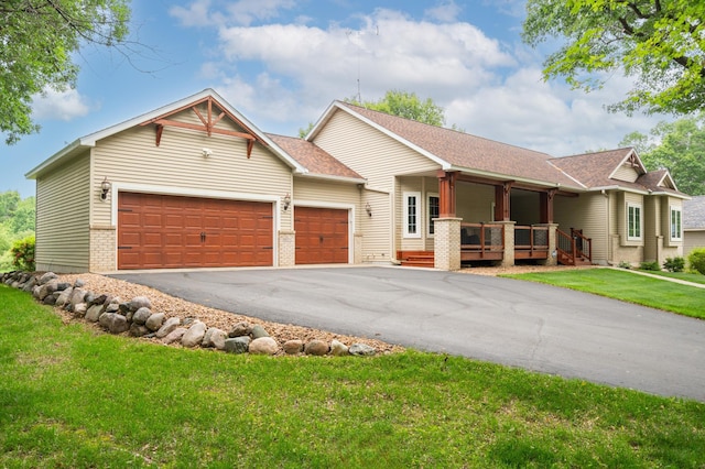 1805 Maple Ln, Saint Cloud, MN 56304 - ranch-style home featuring a garage, asphalt driveway, covered porch, a front yard, and brick siding