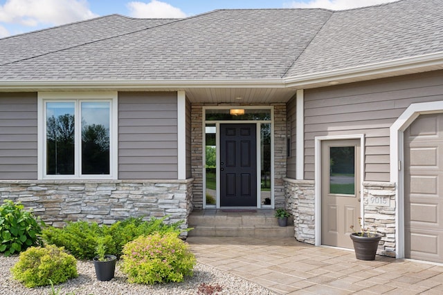 9015 Schutte Ct, Corcoran, MN 55340 - view of exterior entry with stone siding and a shingled roof