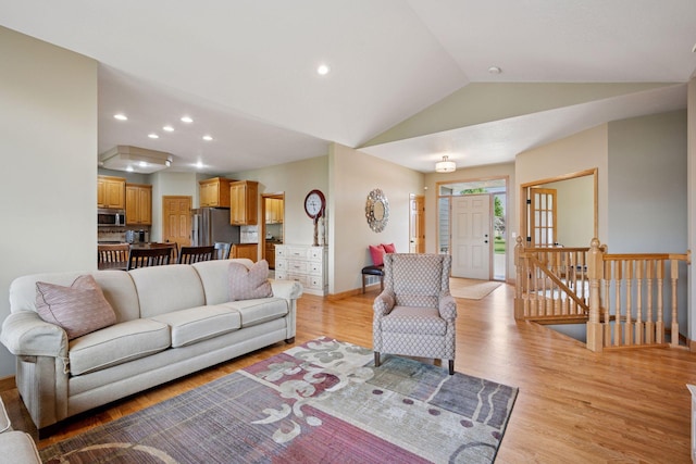 9015 Schutte Ct, Corcoran, MN 55340 - living room featuring lofted ceiling, light wood-style flooring, and recessed lighting