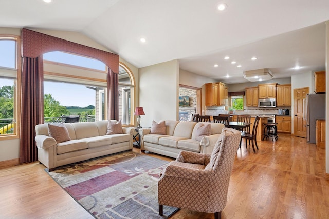 9015 Schutte Ct, Corcoran, MN 55340 - living area featuring light wood-style floors, recessed lighting, and lofted ceiling