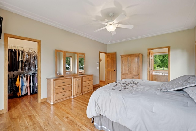 9015 Schutte Ct, Corcoran, MN 55340 - bedroom with a spacious closet, light wood finished floors, a closet, and a ceiling fan
