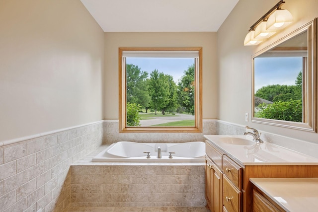 9015 Schutte Ct, Corcoran, MN 55340 - full bath with a bath, wainscoting, vanity, and tile walls