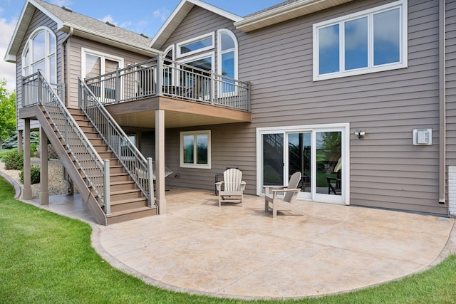 9015 Schutte Ct, Corcoran, MN 55340 - back of property with a patio, a deck, stairway, and a lawn